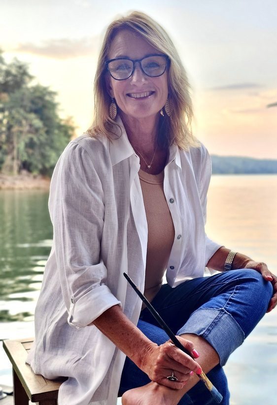 vicki beddingfield seated on the dock by the water