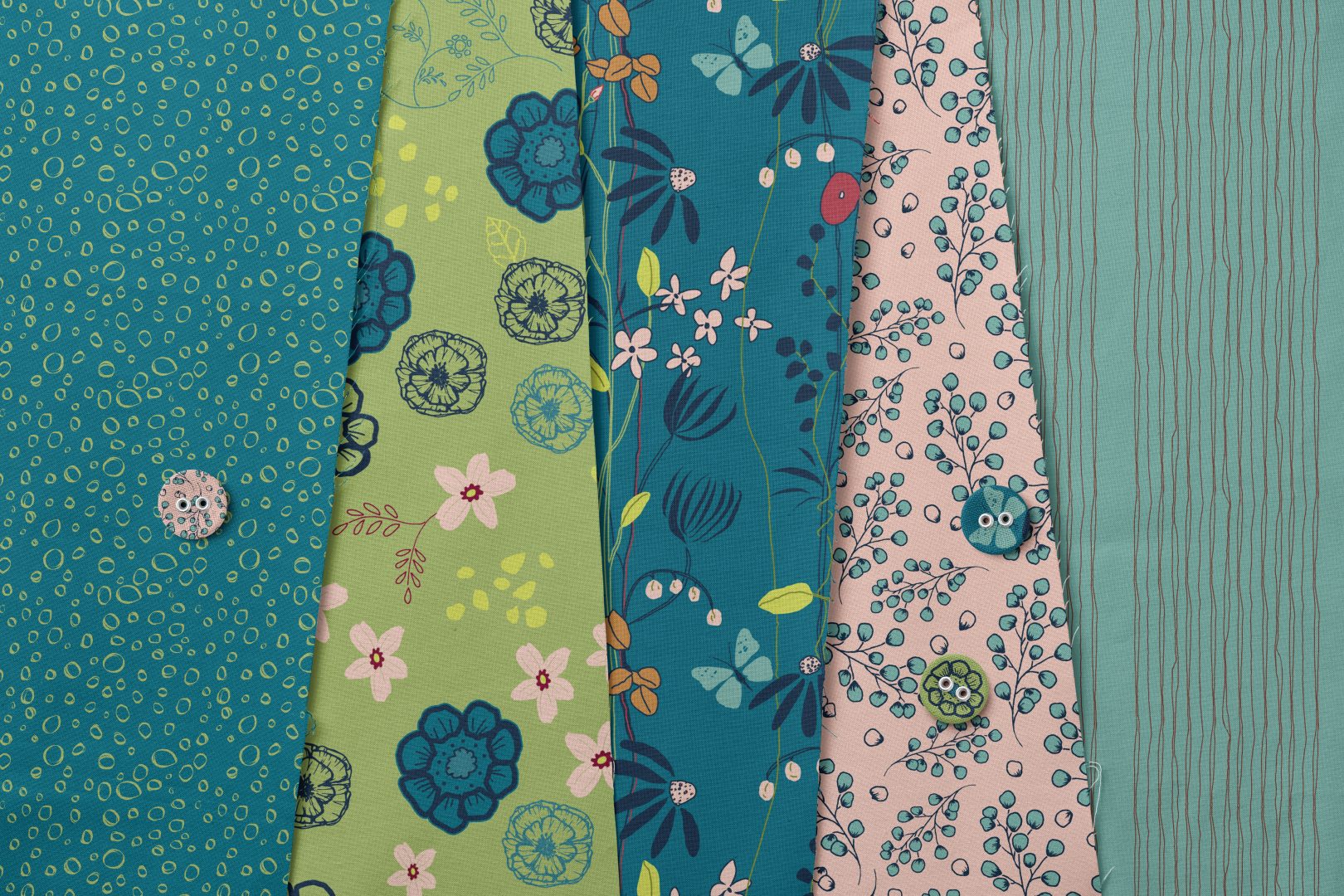 nature's tapestry teal collection on flat lay with buttons